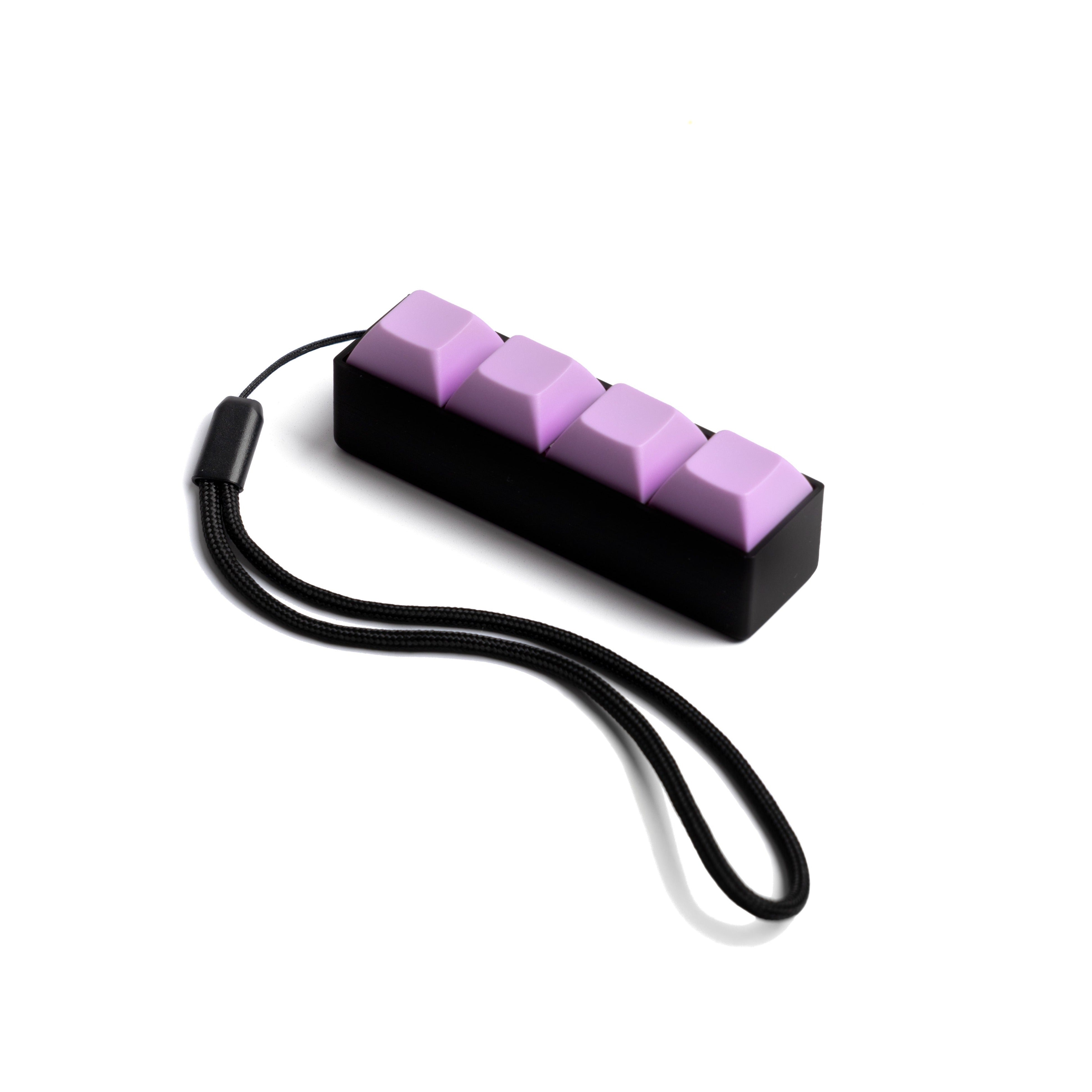 A compact mechanical keyboard keychain with black body and purple keycaps, attached to a wrist strap.